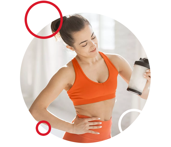 Sports woman with protein shaker at gym